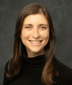woman in black turtleneck smiling