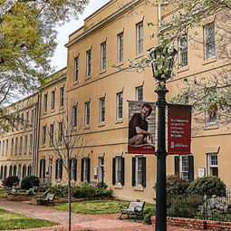 The horseshoe light fixtures and dogwoods blooming in the foreground, Harper Elliott residence hall is in the background