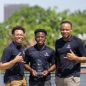 Three men stand on a balcony in black shirts holding a glass award, reading Integrated Marketing Campaign: RecFlix 'N Chill 2025 University of South Carolina.