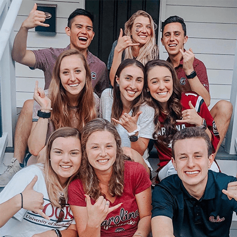 Students on porch before game day