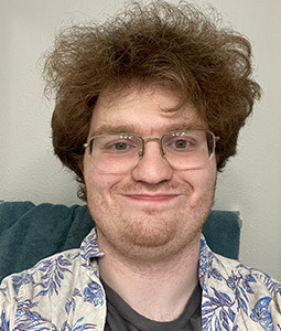 a man with brown hair and glasses