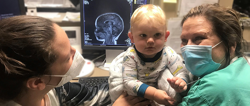 banner of child in medical setting while research is being conducted 