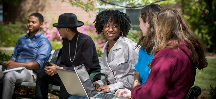 students sitting and chatting outside 