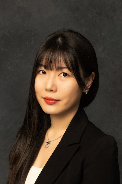 woman with dark hair and blue and white checked shirt on