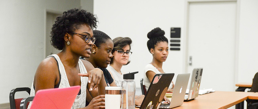 A student poses with the Gamecocks mascot, Cocky.
