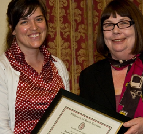 professor presenting award to student
