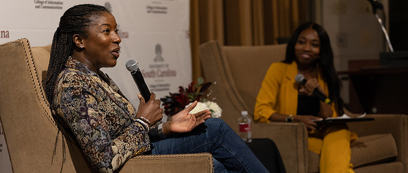 a speaker holding a microphone