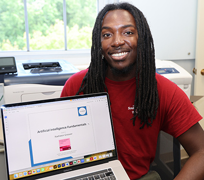 Rae Groover holding a computer