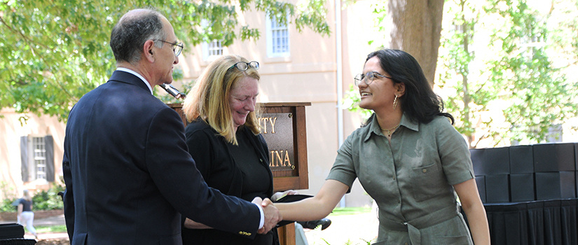 Dean Haj-Hariri and Assistant Dean of Student Services, Ruth Patterson, bestowing an award to a student.