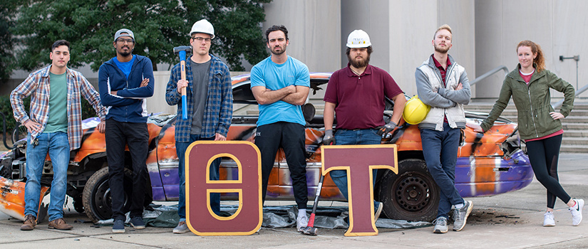 seven students pose in hard hats at the Clemson car smash event