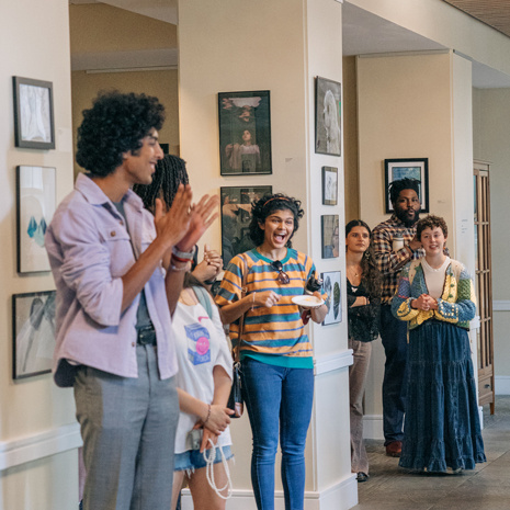 Students cheering at the Honors Art Exhibition