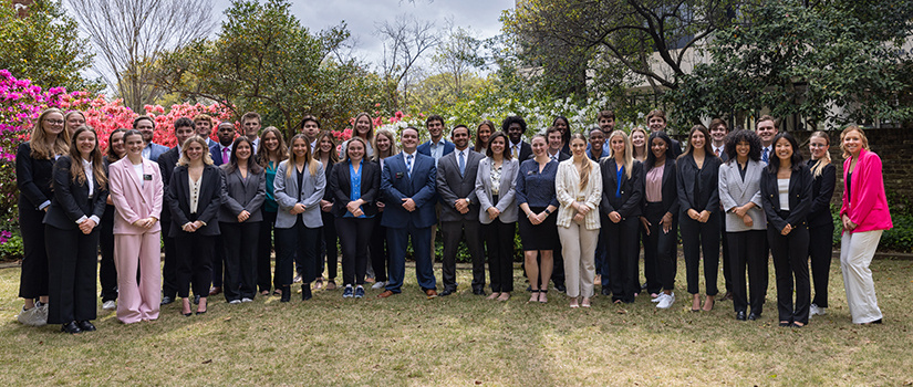 HRSM Student Leaders pose in a garden next to the Close-Hipp Building.