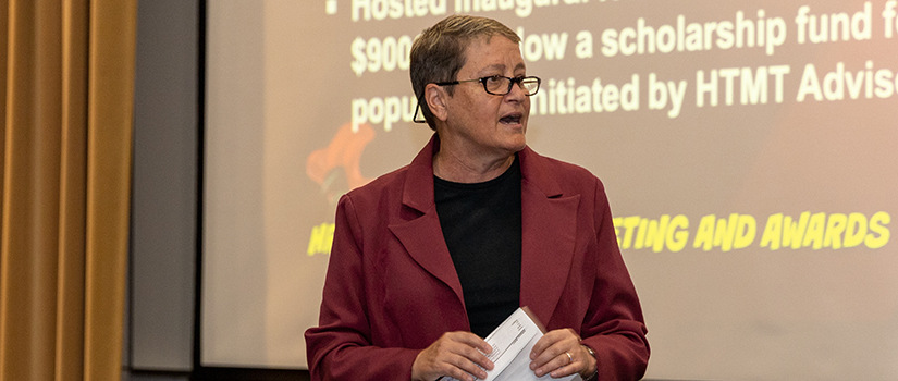 Professor Robin DiPietro speaks to an audience in the Belk Auditorium.