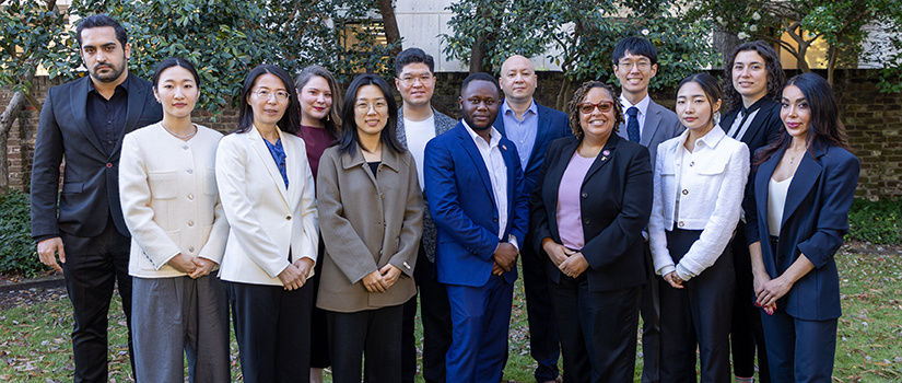 Hospitality and tourism Ph.D. students pose for a photo director Fang Meng.
