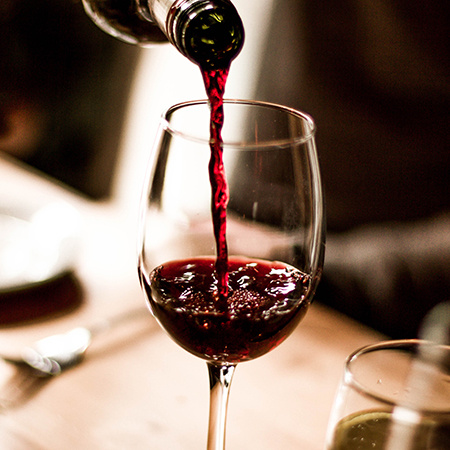 Red wine pouring in a glass