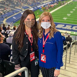 Maddie Ballengee stands with a colleague during a Dallas Cowboys game