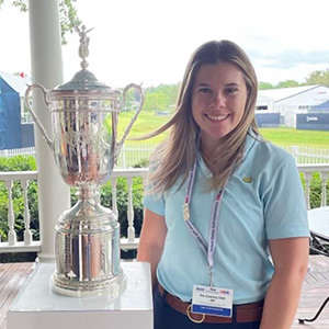 Lexie Bado poses next to the US Open trophy.