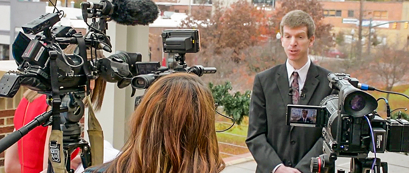 Joey Von Nessen talking with press at an Economic Outlook Conference