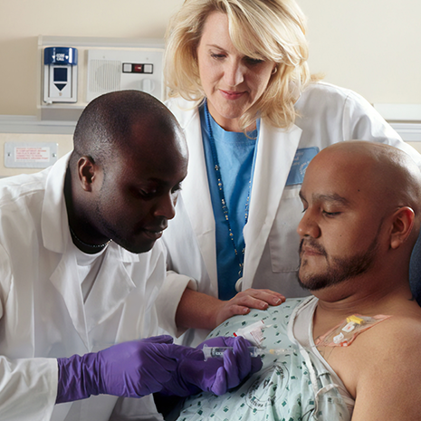 Pharmacist and doctor with patient