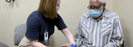 garnet bar with image of pharmacist in community pharmacy