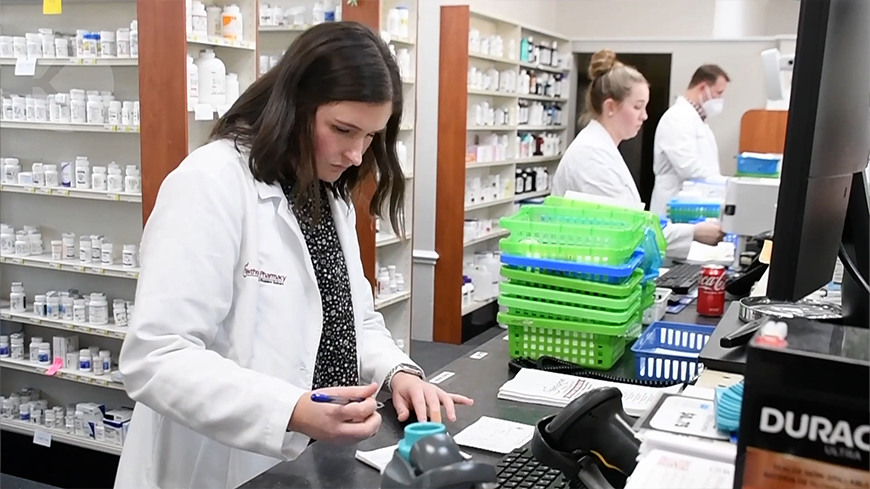 Pharmacist behind a counter