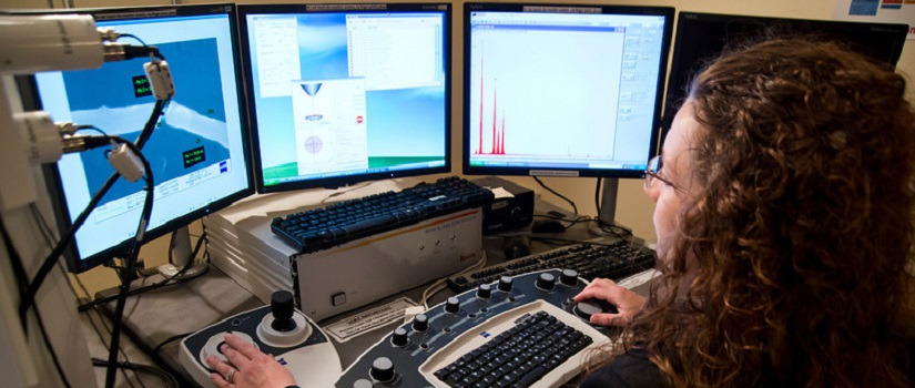 Woman working at her computer with three screens