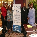 Group of people standing around an informational poster