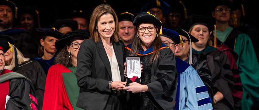 An alumni of the university accepting an achievement award