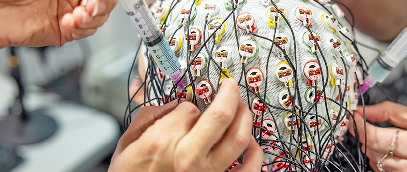 Close-up of a person wearing a cap that measures brain activity