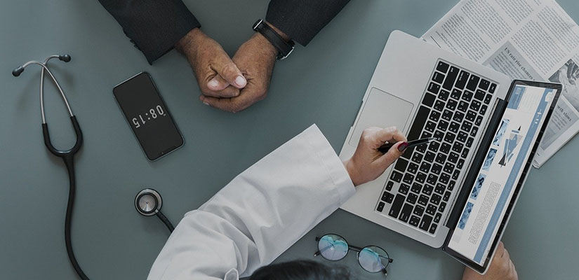 Doctor talking with patient over computer