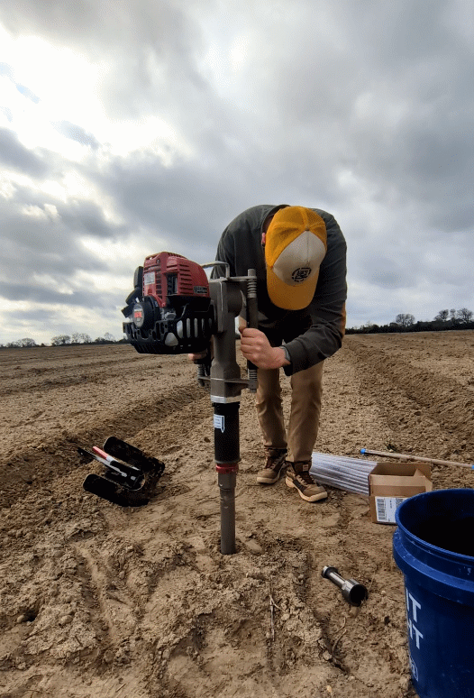 person sampling soil