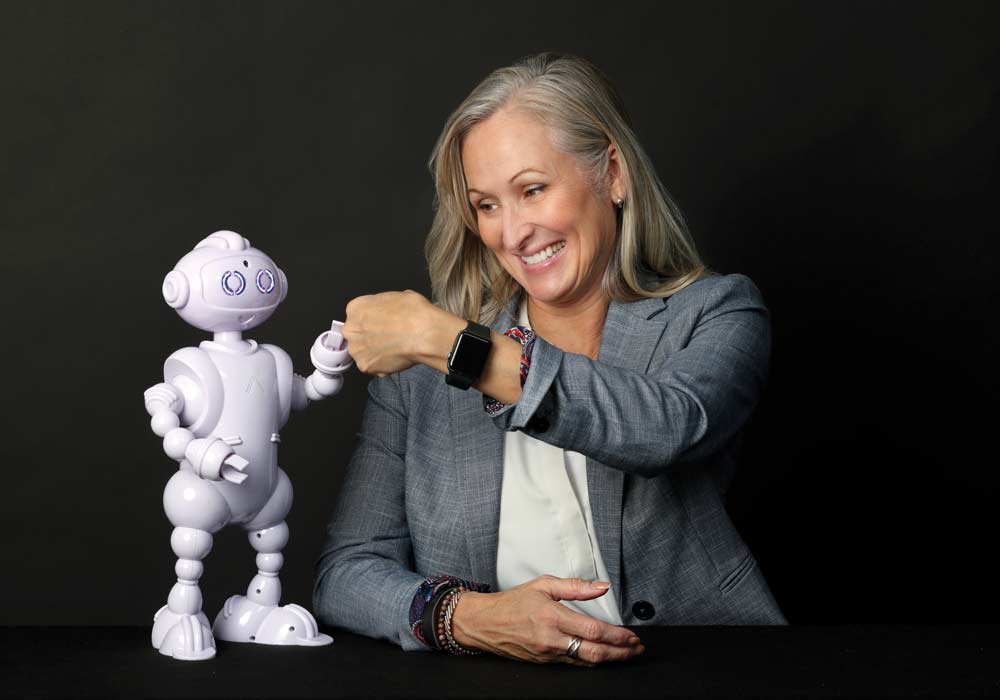 Lauren Boccanfuso shares a fist bump with ABii, her educational robot.