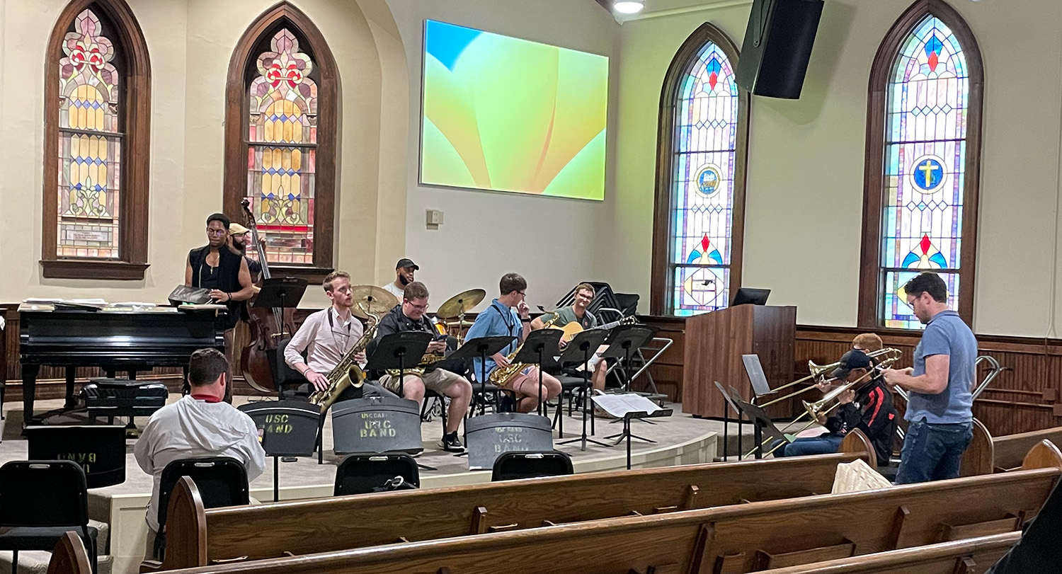 Jazz musicians practicing in a church sanctuary