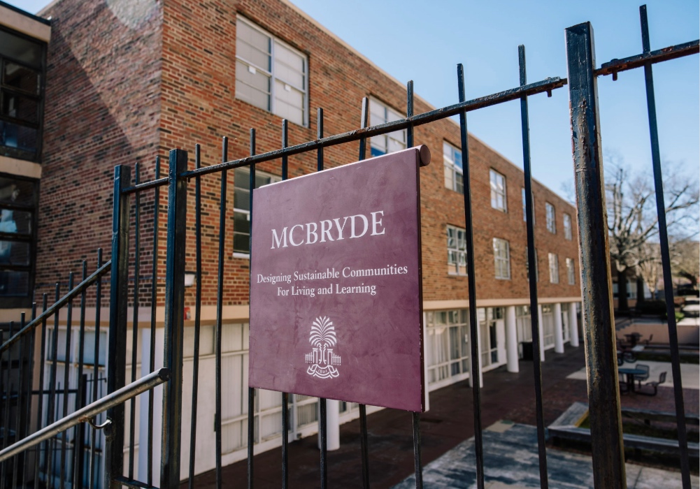 Image of the McBryde Hall residence sign on fence.