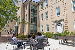 students sitting in a courtyard on campus