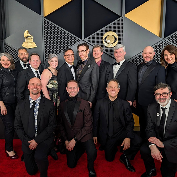 Group in formal wear on a red carpet