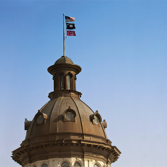 south carolina flag flying atop the statehouse