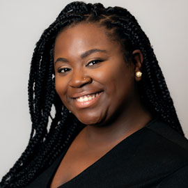 Headshot of senior exercise science major, Taylor Outler, in front of a plain grey background 