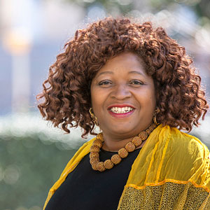 Woman wearing a yellow scarf with blurred background