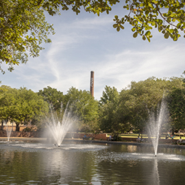 The USC smokestack rises above the Thomas Cooper Library fountain