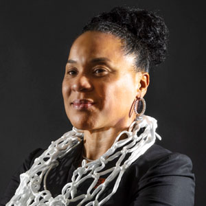 A studio portrait of Dawn Staley with net around her neck.