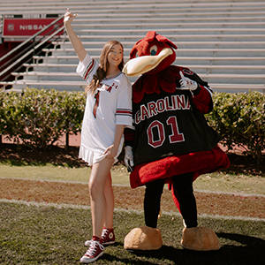 Sarah Sylvester and Cocky pose on Williams Brice Stadium.