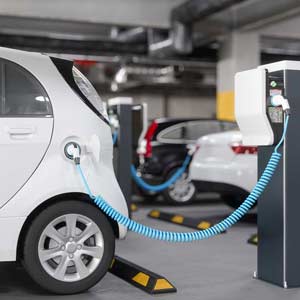 An electric car being charged in a parking garage.