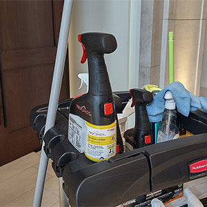 The TruShot cleaning cartridge in its spray bottle on a custodian's cart