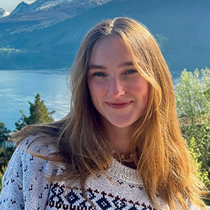 Woman in a mountain setting with lake in valley below