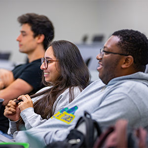 three students smiling in class