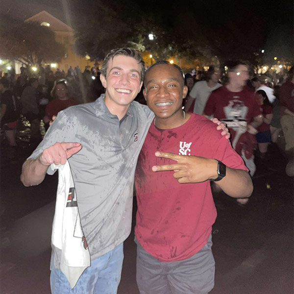 Jaheem McLaurin, right, celebrated the 2022 women's basketball championship at the Thomas Cooper Library fountain.