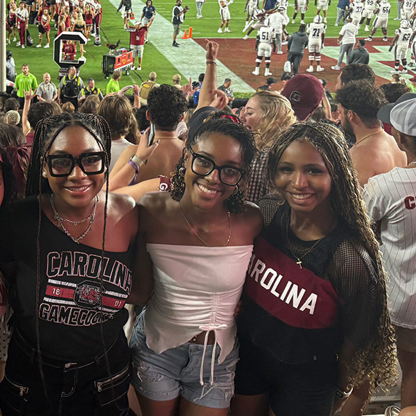 Sierra Brent stands with two friends during a game at Williams-Brice Stadium.
